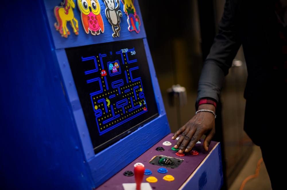 Presenter showing their Pac Man arcade machine